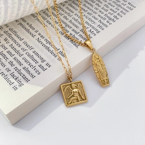 Detailed relief of an angel and religious figure on vintage gold-plated pendants