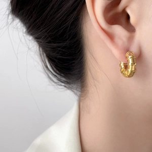 Close-up of golden multi-layer bamboo hoop earrings in 18K gold plated stainless steel