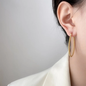 18K gold plated titanium steel beaded hoop earring worn by a model in a close-up shot
