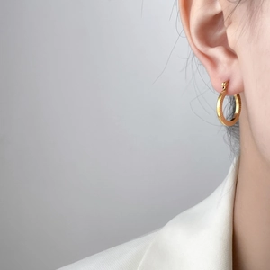 18K gold plated titanium round hoop earrings with sunburst texture on elegant model