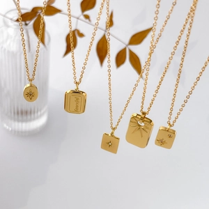 Five 18K gold plated titanium necklaces with engraved star pendants and tiny crystals