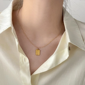 Detail of Graceful engraved rectangular pendant on a fine gold-plated chain for women