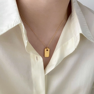 Minimalist 18K gold plated stainless steel square pendant necklace on woman's neck
