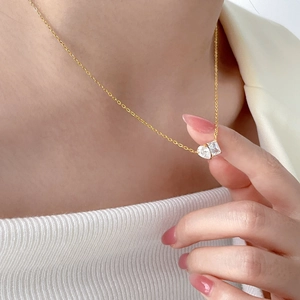 Collana in titanio placcato oro con gemme quadrate e rettangolari su una catena delicata