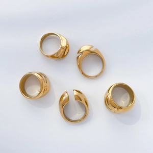 Detailed close-up of 18K gold plated titanium steel rings with textured concave surfaces