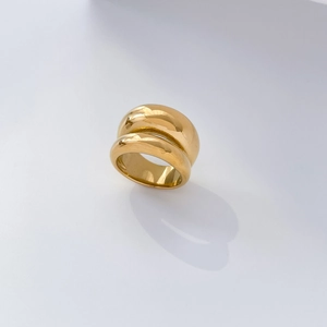 Detail of wide 18K gold plated ring with a layered concave arc and fold design
