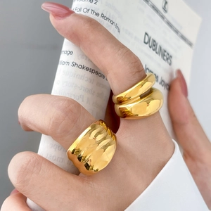 Detail of 18K gold plated chunky wave and double layer rings on model hand