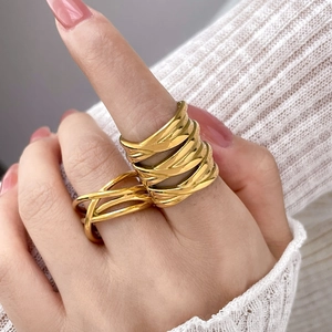 Polished 18K gold plated multi-layer woven titanium steel ring worn by a model