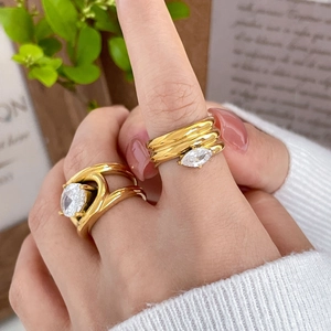 Detail of 18K gold plated titanium multi-layer spiral rings with oval zircon stones