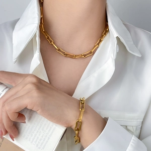 Minimalist gold-plated link chain jewelry set with necklace and bracelet on model