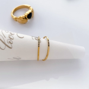 Detailed set of three gold-plated rings featuring a black heart-shaped zircon stone