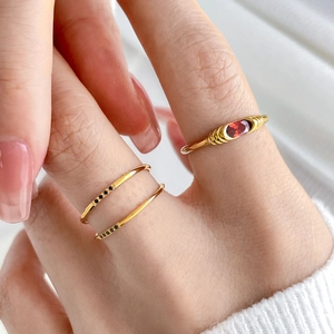 French vintage gold rings set with red oval gemstone and minimalist black zircon bands