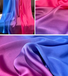 Close-up of gradient satin fabric showing blue to purple and rose red smooth color transition