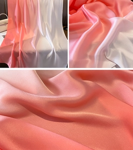 Detailed view of the smooth gradient pink to white satin fabric with a silky glossy texture