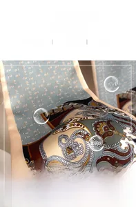 Close-up of paisley silk scarf showing soft satin texture and detailed inner stitching