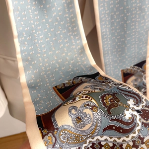 Detail of vintage paisley silk scarf showing soft drape and dual-pattern satin texture