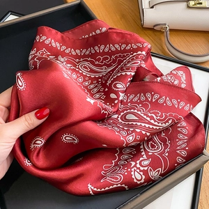 Luxurious red silk square scarf with white paisley pattern displayed in a premium gift box