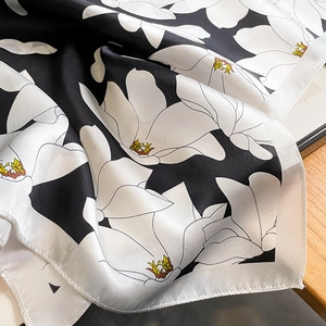 Elegant silk scarf with white magnolia floral pattern on black background for women