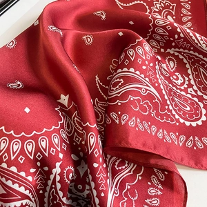 Elegant dark red paisley silk scarf with glossy satin finish and smooth rolled edges