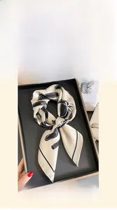 Detail of 70cm champagne silk scarf with black abstract print in elegant gift box