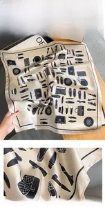 Detail of elegant silk scarf showing high-quality stitching and chic fashion print
