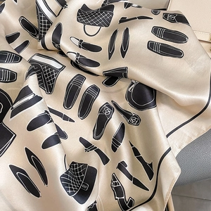 Detailed view of champagne silk scarf with hand-drawn luxury fashion pattern