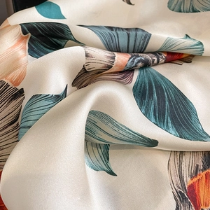 Silk square scarf with abstract leaf print in teal and orange hues for women