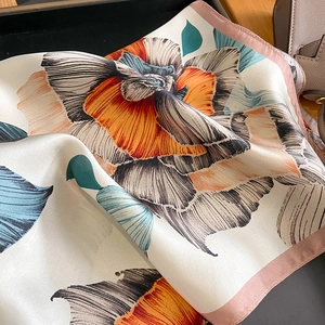 Floral print silk square scarf featuring vibrant orange and blue petals with pink edges