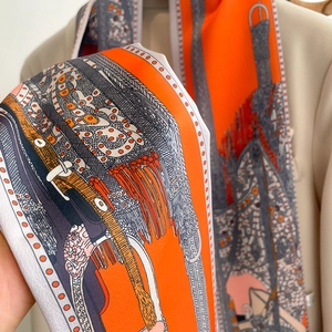 Vue détaillée d'un foulard en soie orange à motif équestre porté sur un blazer beige