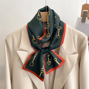 Foulard en soie vert foncé avec motif chaîne de style français sur blazer beige