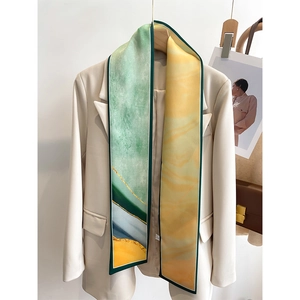 Detail of artistic oil painting print twilly scarf styled on a beige suit jacket