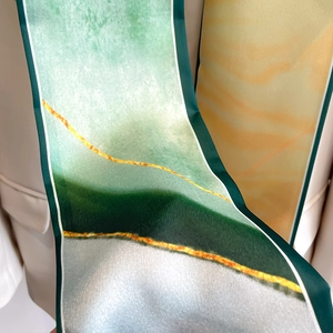 Macro shot of silk scarf detailing satin texture and abstract mountain oil painting pattern