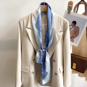 Silk-like landscape oil painting skinny scarf styled on a beige blazer for women