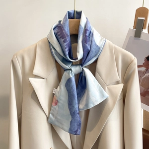Blue oil painting landscape silk scarf tied on a white blazer showing elegant texture