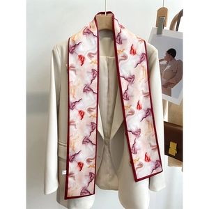 Detailed view of long silk-feel neck scarf with red abstract artistic marble pattern