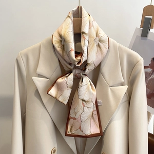 Élégante écharpe étroite en soie beige avec motif floral brun et un blazer blanc