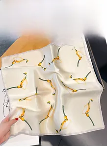 Detailed view of silk scarf featuring retro yellow Calla Lily floral prints on beige fabric