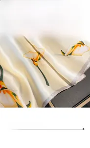 Detail view of champagne silk scarf featuring premium stitching and white calla lily patterns