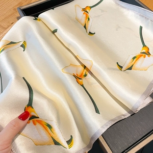 Elegant silk scarf with yellow calla lily floral pattern on creamy white satin fabric