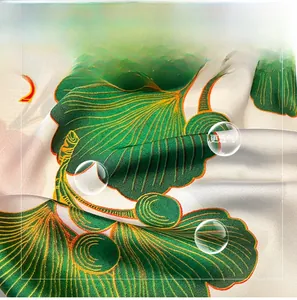 Close-up of faux silk scarf with elegant green ginkgo leaf print and satin finish texture