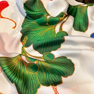 Elegant white silk scarf with green ginkgo leaves and red floral accents for beach and sun