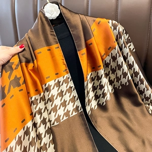 Fashionable houndstooth silk scarf with orange and brown geometric patchwork pattern