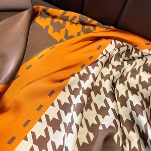 Fashionable houndstooth silk shawl featuring stylish orange and brown geometric patterns