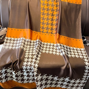 Elegant houndstooth silk scarf with orange and brown geometric patterns for sun protection