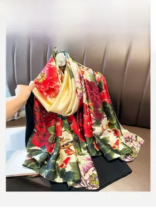 Detail of satin silk scarf with red peony and koi fish patterns on black fabric