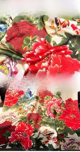 Detail of silk scarf showing vibrant peony and koi print with fine stitching edges