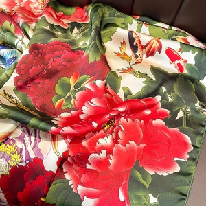 Fashionable silk scarf with vibrant red peony flowers and koi fish on beige background