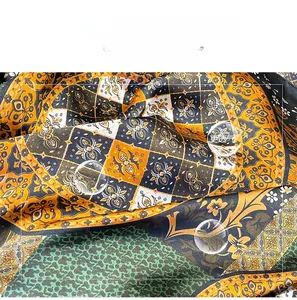Close-up of silk-like floral shawl with yellow geometric and leopard print patterns