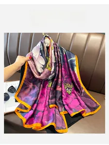 Detail of silk-like floral scarf showing drape and orange contrast rolled edges
