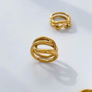 Detailed view of wide 18K gold plated hollow twist ring with abstract layered lines